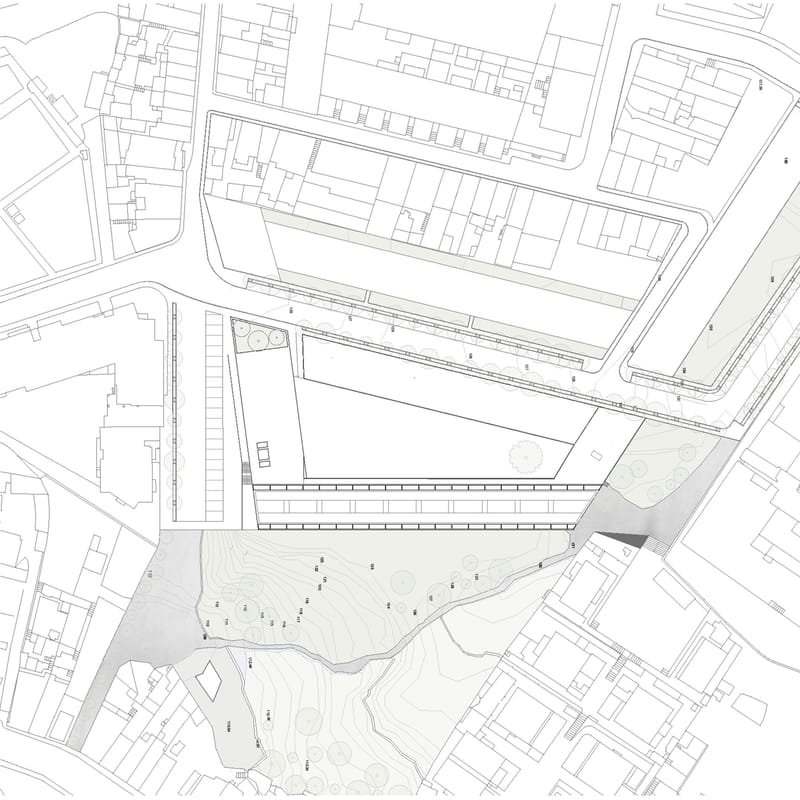 Site plan of the student residence and cultural building within the surrounding city blocks and terrain.